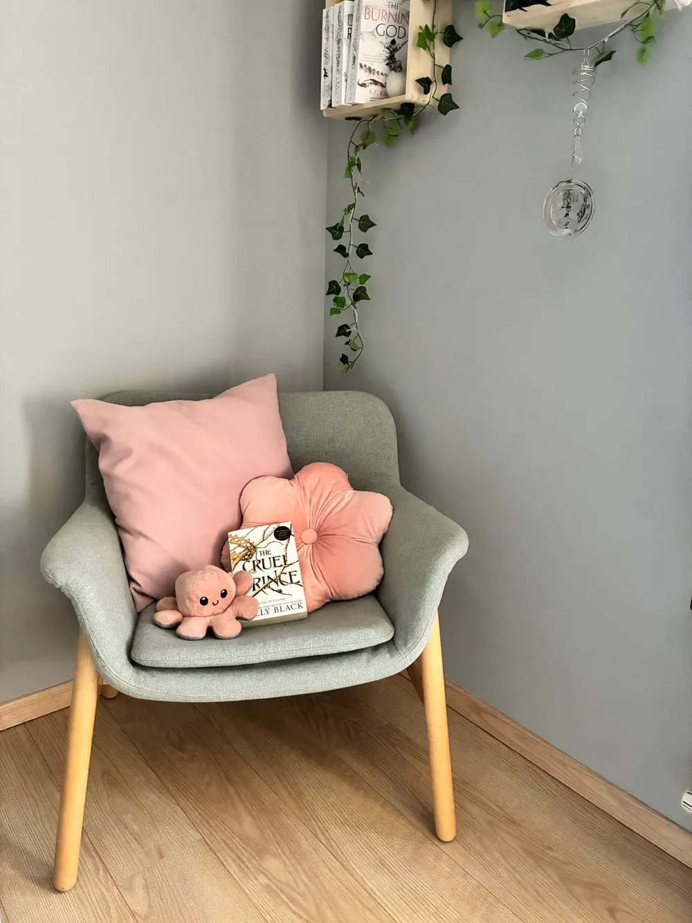 A cozy corner with a pastel chair, plush toys, and books for a relaxing vibe.
